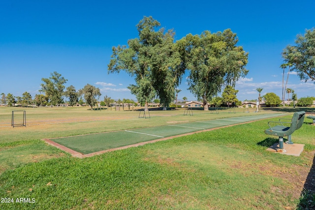 view of property's community with a lawn