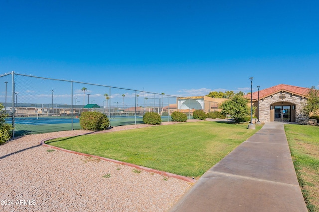 surrounding community with a lawn and tennis court