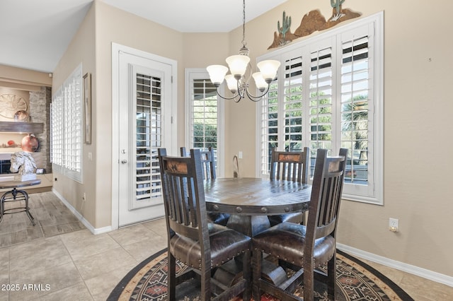 tiled dining room featuring an inviting chandelier