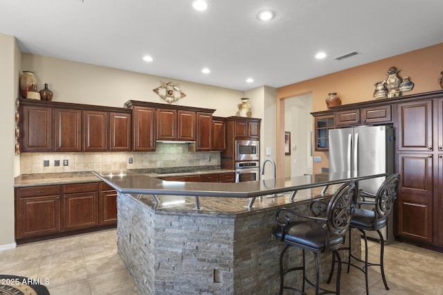 kitchen featuring a breakfast bar, a large island, and stainless steel appliances