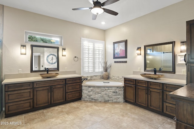 bathroom featuring vanity, a washtub, and ceiling fan