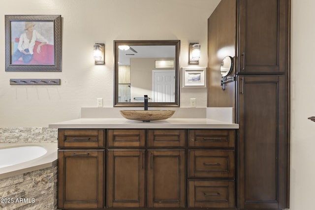 bathroom with a bath and vanity