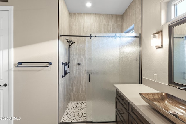 bathroom featuring vanity and a shower with shower door