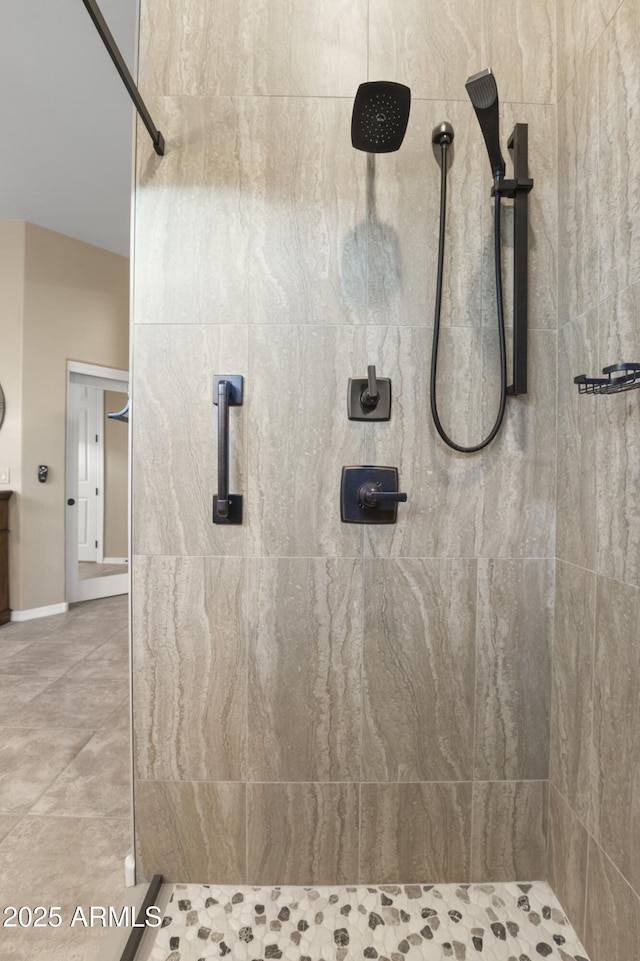 bathroom with tile patterned floors and a tile shower