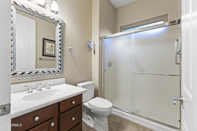 bathroom featuring vanity, toilet, walk in shower, and tile patterned flooring