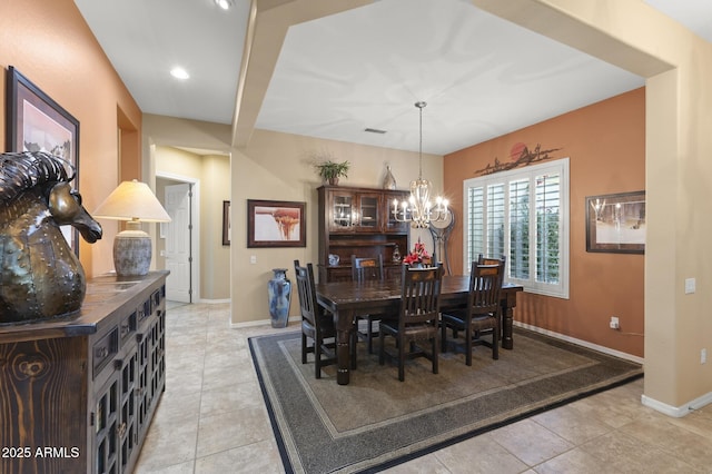 tiled dining space with a notable chandelier