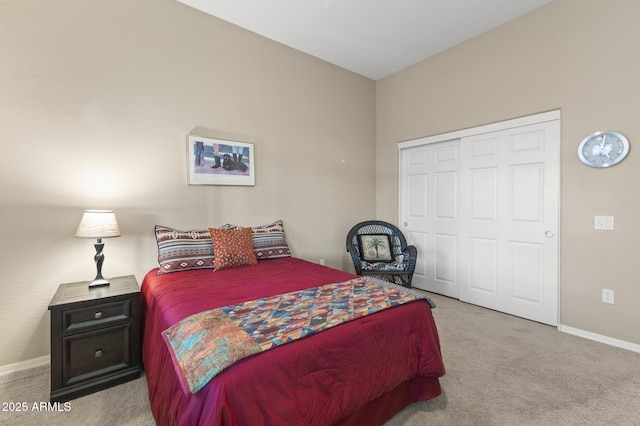 bedroom featuring a closet and light colored carpet