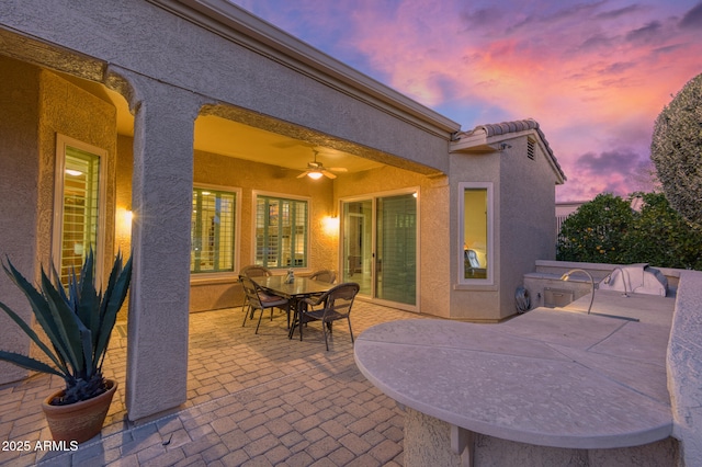 patio terrace at dusk with ceiling fan