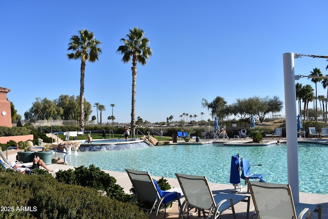 view of pool with a hot tub and pool water feature