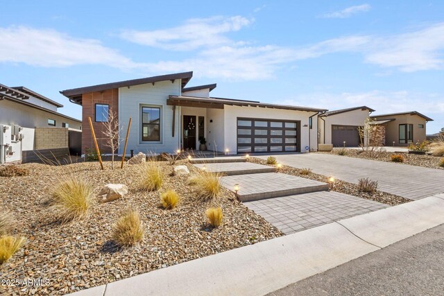 4947 N Mclaury Dr, Prescott Valley, AZ 86314 - contemporary house with decorative driveway, a garage, and fence