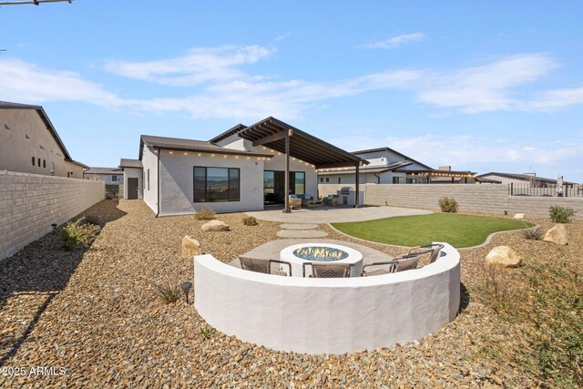 4947 N Mclaury Dr, Prescott Valley, AZ 86314 - rear view of house with stucco siding, a patio, a fenced backyard, a fire pit, and a yard