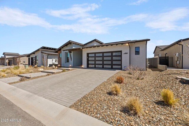 4947 N Mclaury Dr, Prescott Valley, AZ 86314 - contemporary home featuring stucco siding, an attached garage, and decorative driveway