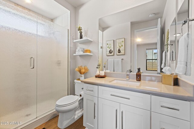 4947 N Mclaury Dr, Prescott Valley, AZ 86314 - full bathroom featuring a stall shower, wood finished floors, toilet, and vanity