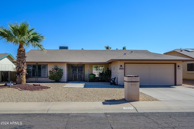 ranch-style home with concrete driveway and an attached garage