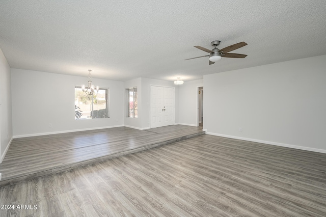 unfurnished living room with wood-type flooring, a textured ceiling, and ceiling fan with notable chandelier