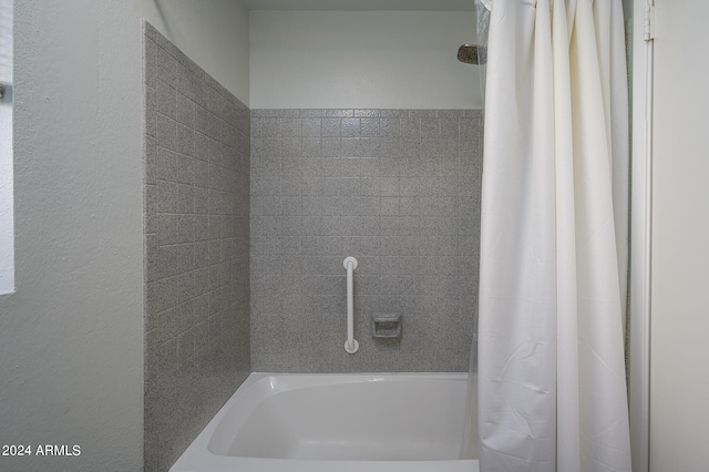 bathroom with shower / bath combination with curtain