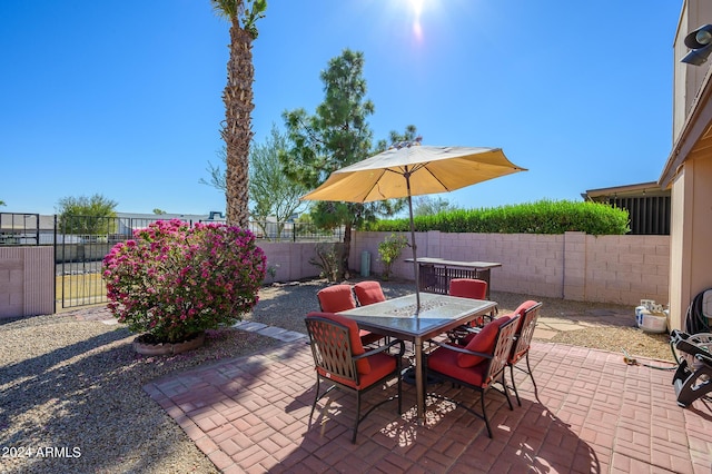 view of patio featuring outdoor dining area and a fenced backyard