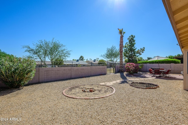 view of yard featuring a patio area, a fenced backyard, and outdoor dining area