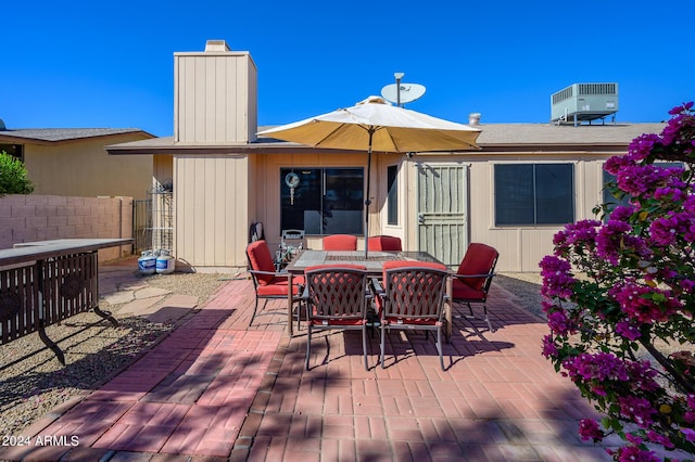 deck featuring a patio area, fence, central AC unit, and outdoor dining space