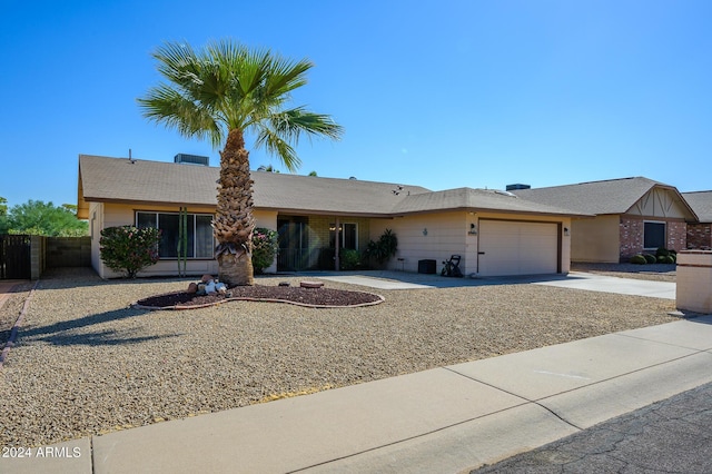 single story home featuring an attached garage and concrete driveway