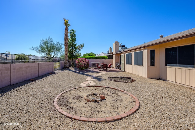 view of yard with a patio area and a fire pit