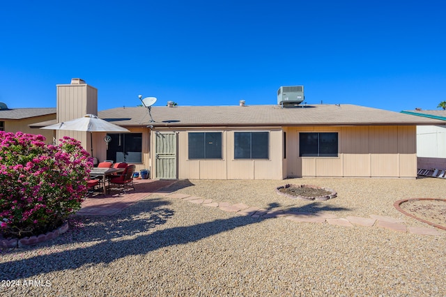 rear view of house featuring central AC unit and a patio area