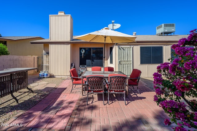 wooden deck with central AC unit and a patio