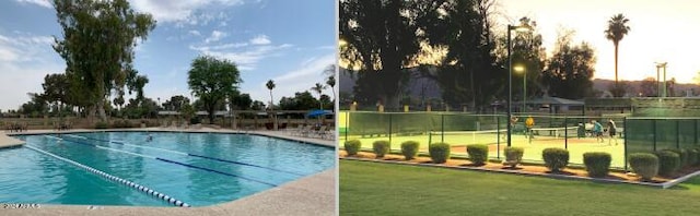 view of pool featuring a lawn and fence