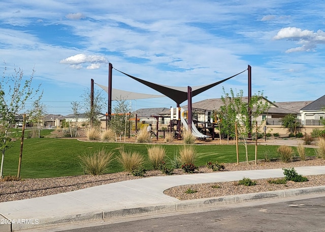 communal playground with a yard and a residential view