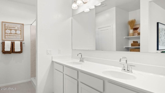 bathroom with a sink, walk in shower, and tile patterned flooring