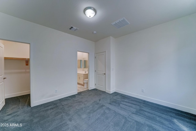 4927 S Tune, Mesa, AZ 85212 - unfurnished bedroom featuring dark carpet, a spacious closet, and ensuite bathroom