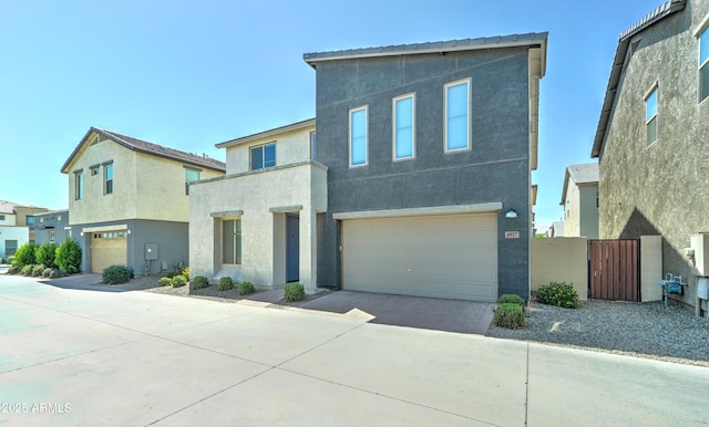 4927 S Tune, Mesa, AZ 85212 - view of front of house with an attached garage, concrete driveway, stucco siding, and a gate