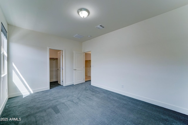 4927 S Tune, Mesa, AZ 85212 - unfurnished bedroom with dark carpet and a spacious closet