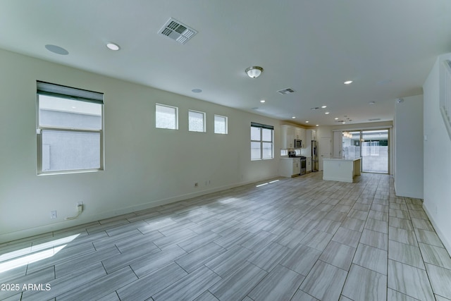 4927 S Tune, Mesa, AZ 85212 - unfurnished living room featuring recessed lighting and baseboards