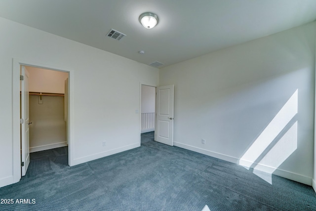 4927 S Tune, Mesa, AZ 85212 - unfurnished bedroom featuring dark carpet and a walk in closet