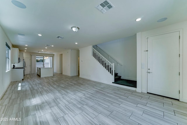 4927 S Tune, Mesa, AZ 85212 - unfurnished living room with stairs and recessed lighting