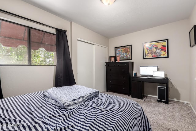 carpeted bedroom featuring a textured ceiling and a closet