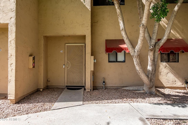 property entrance featuring stucco siding