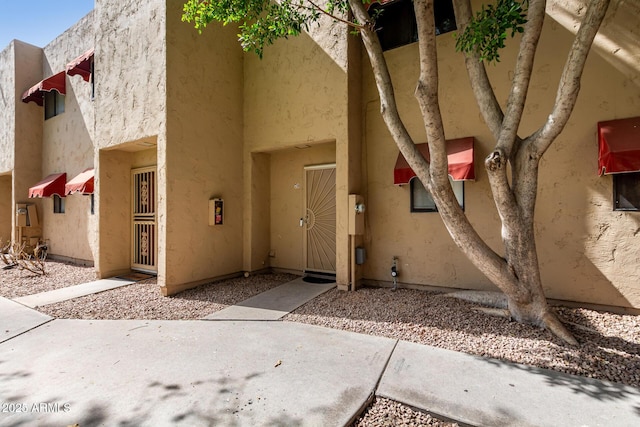 entrance to property with stucco siding