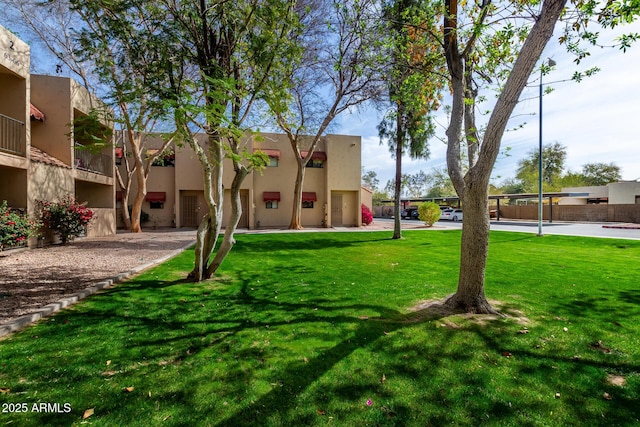 view of property's community featuring a residential view and a yard