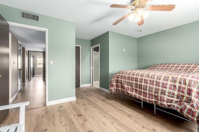 bedroom with visible vents, baseboards, ceiling fan, and hardwood / wood-style floors