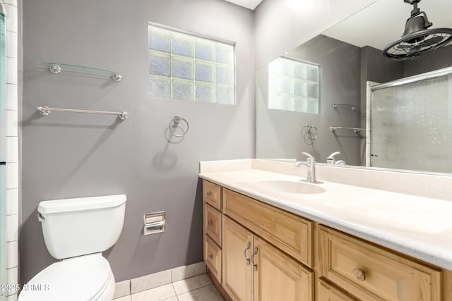 full bath with vanity, toilet, baseboards, an enclosed shower, and tile patterned floors