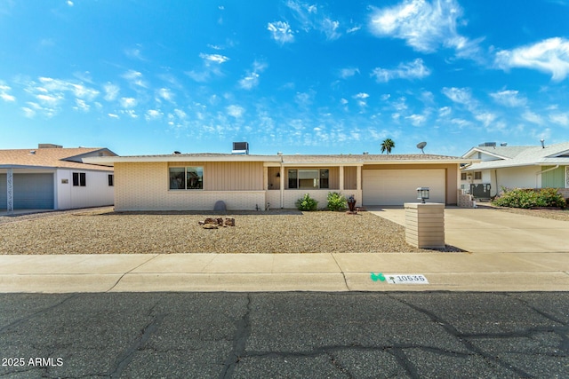 ranch-style home with brick siding, an attached garage, and driveway
