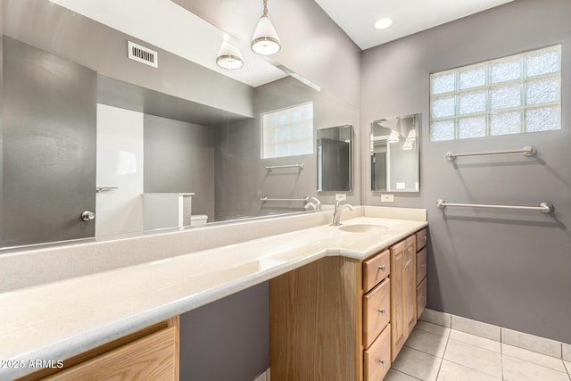 bathroom with visible vents, plenty of natural light, tile patterned flooring, and vanity