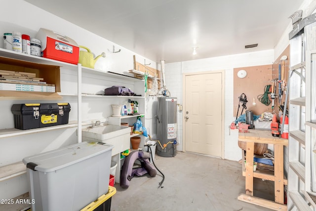storage room featuring a sink and water heater