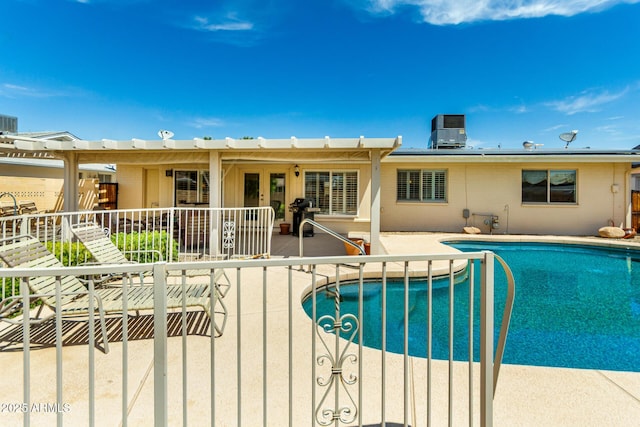 outdoor pool with french doors, central AC unit, and a patio area