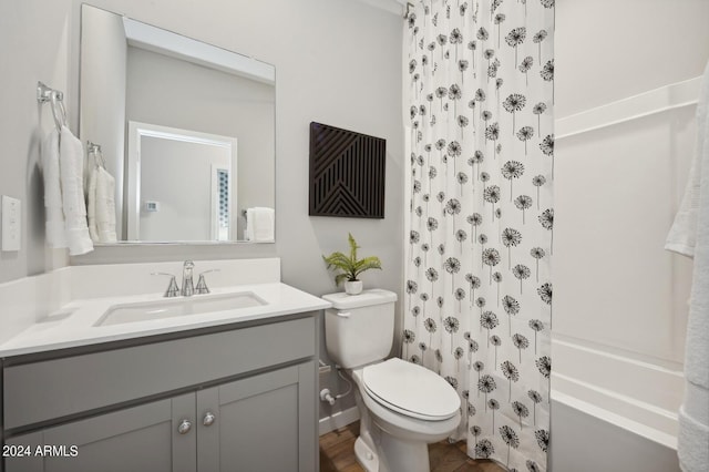 full bathroom featuring vanity, hardwood / wood-style flooring, toilet, and shower / tub combo with curtain