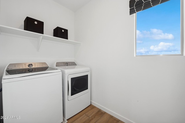 laundry room featuring independent washer and dryer and hardwood / wood-style flooring