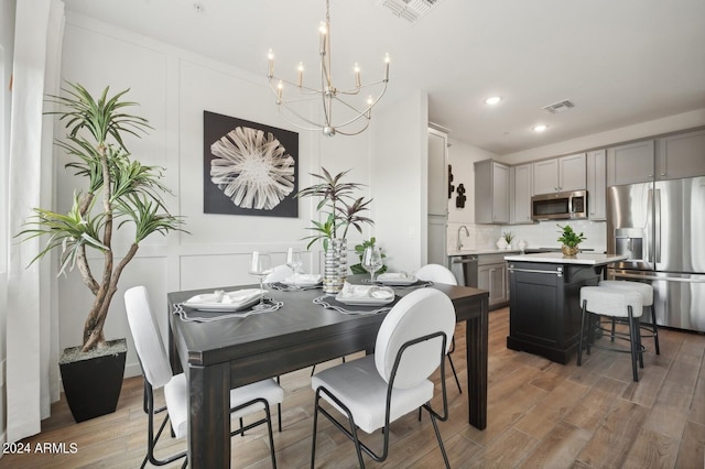 dining space featuring a notable chandelier and wood-type flooring