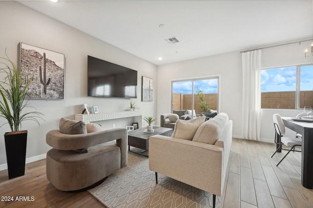 living room with a wealth of natural light and light hardwood / wood-style floors